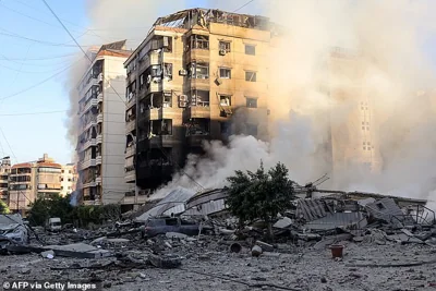 Smoke rises from the rubble of a building that which levelled in overnight Israeli bombardment on Beirut's southern suburbs, on September 28