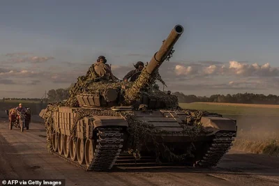 Ukrainian servicemen operate a Soviet-made T-72 tank in the Sumy region near the border with Russia