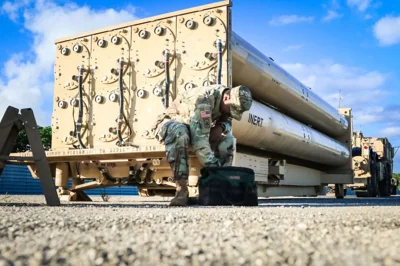 A US Army soldier in front of a THAAD anti-missile defence system