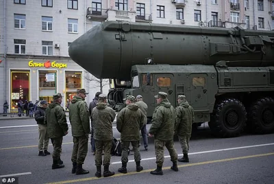 Soldiers stand next to a Russian RS-24 Yars ballistic missile parked along Tverskaya street prior to a rehearsal for the Victory Day military parade in Moscow, on Thursday, May 2, 2024