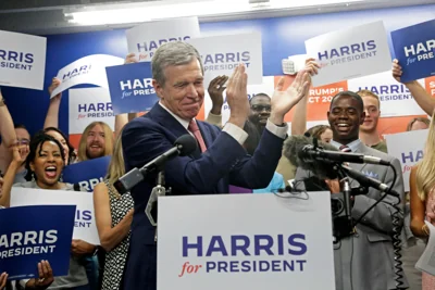 N.C. Governor Roy Cooper claps as he speaks at a news conference, Thursday, July 25, 2024, in Raleigh, N.C. Cooper had been considered a potential running mate for Harris.