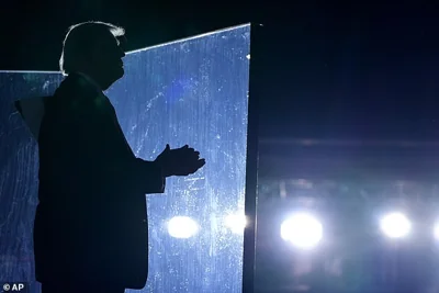 Republican presidential nominee former President Donald Trump listens as Christopher Macchio, not pictured, sings at the conclusion of a campaign event at the Butler Farm Show, Saturday, Oct. 5, 2024