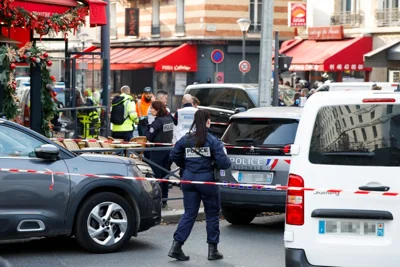 Police officers block the road near the restaurant “Pizza L’Olivier” in Issy-les-Moulineaux, suburbs of Paris