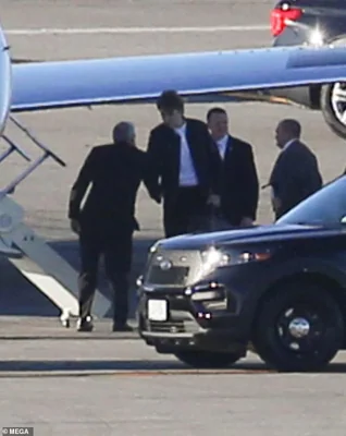 Barron Trump, 18, shakes hands with his security detail before boarding the private Cessna Citation plane in New York City on Sunday