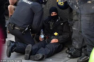 LIVERPOOL: Police officers attend to a shell-shocked colleague after a face-off with protesters