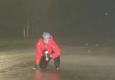 At one stage a waterlogged Ray was forced to crouch down onto the ground because the winds were so strong