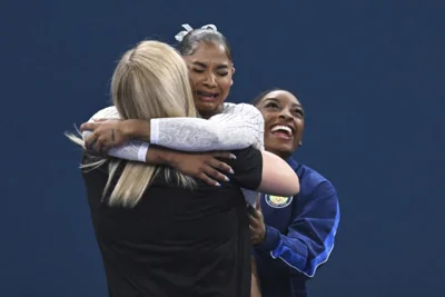 Jordan Chiles celebrates her bronze medal as Simone Biles looks on, right. 