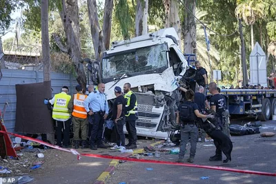 A truck driver rammed his vehicle (pictured) into a crowd of people at a bus stop in central Israel on Sunday, injuring at least 35 people