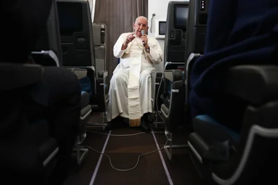 Pope Francis holds a news conference aboard the papal plane on his flight back after his 12-day journey across Southeast Asia and Oceania