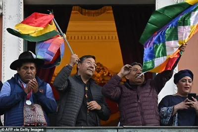 Bolivian President Luis Arce (2nd L) waves a Bolivian flag at the balcony of the Government Palace in La Paz on June 26, 2024