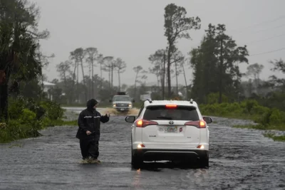 A man walks through storm surge on the flooded road into Horseshoe Beach, Fla., Monday morning, Aug. 5, 2024. AP PHOTO