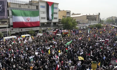 People follow a truck carrying the coffins of Hamas' political leader Ismail Haniyeh and his bodyguard who were killed in an assassination on July 31, 2024, during their funeral ceremony in Tehran, Iran on August 1, 2024. Photo: VCG