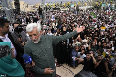 Saeed Jalili, a former Iran's top nuclear negotiator, speaks with state-run TV reporter during his campaign meeting in Tehran, Iran, Monday, June 24, 2024