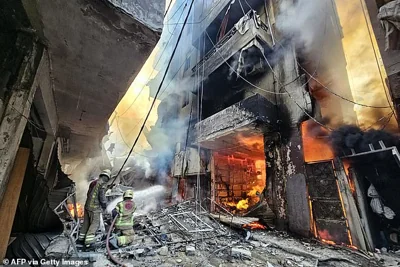 Firefighters battle the flames after a building was hit in an Israeli airstrike in the Hadath neighbourhood of Beirut's southern suburbs