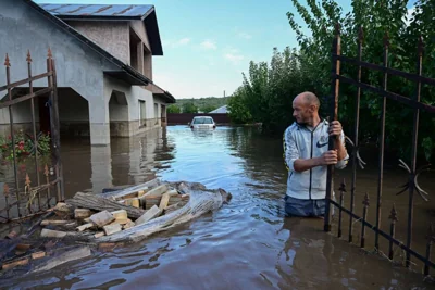 A man inspects a flooded house in the Romanian village of Slobozia Conachi on September 14 2024. AFP PHOTO