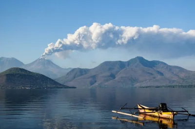 Mount Lewotobi Laki Laki spews ash and smoke during an eruption as seen from Lewolaga village in Titihena, East Nusa Tenggara, on November 13, 2024. (Photo by Arnold Welianto / AFP)