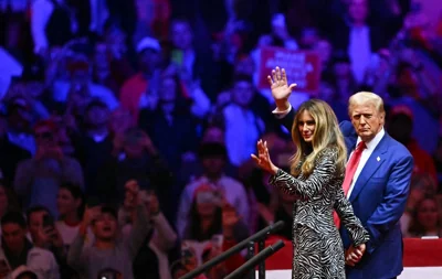 Former US President and Republican presidential candidate Donald Trump and his wife former US First Lady Melania Trump wave as they leave a campaign rally at Madison Square Garden in New York, October 27, 2024. AFP PHOTO