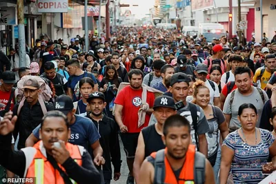 Migrants walk in a caravan during the Presidential election day, in an attempt to reach Mexico's northern border