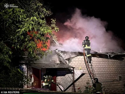 Firefighters work at a site of a residential building damaged during a Russian drone strike, in Kyiv region, Ukraine July 31