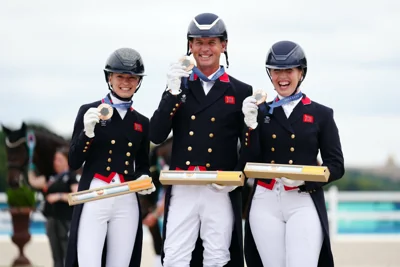 Great Britain trio Charlotte Fry, Carl Hester and Becky Moody after winning a bronze medal in the dressage team Grand Prix Special at Paris 2024 (Mike Egerton/PA)
