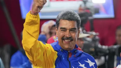 President Nicolas Maduro addresses supporters after electoral authorities declared him the winner of the presidential election in Caracas, Venezuela on Monday