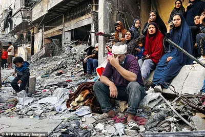 An injured man reacts while sitting on the rubble of a building hit by an Israeli strike in Beit Lahia, in the northern Gaza Strip, on October 29, 2024, amid the ongoing war between Israel and Hamas