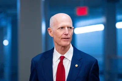 Rick Scott arrives for a vote at the Capitol