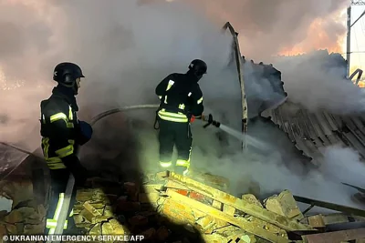 Ukrainian rescuers work to extinguish a fire at an energy infrastructure facility following a missile attack in Lutsk on November 28