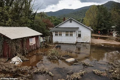 An American flag hangs above floodwaters remaining from Hurricane Helene in Swannanoa, North Carolina