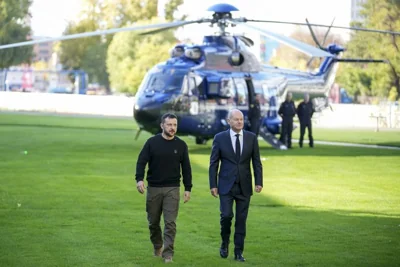 Ukraine's President Volodymyr Zelenskyy, left, and German Chancellor Olaf Scholz arrive for a meeting at the chancellery in Berlin, Germany, Friday, Oct. 11, 2024.