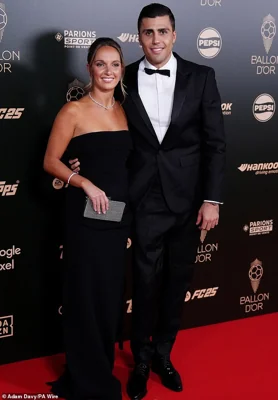 The 28-year-old Spanish midfielder hobbled down the red carpet with his wife Laura Iglesias