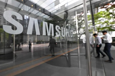 TENFOLD People walk past the Samsung logo displayed on a glass door at the company’s Seocho building in Seoul on Tuesday, April 30, 2024. Samsung Electronics said on Tuesday that its first-quarter operating profits increased by 931.8 percent on the back of recovering chip prices and growing demand. AFP PHOTO