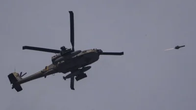 An Israeli Apache helicopter fires a missile towards the Gaza Strip, as seen from southern Israel, Tuesday, May 28, 2024.