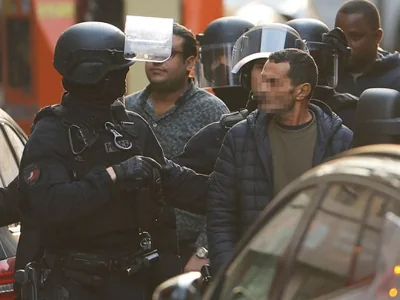 A hostage is accompanied by a police officer 