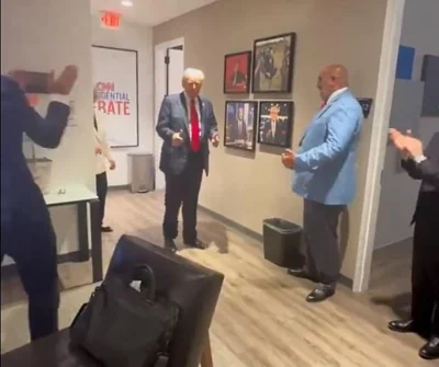 Trump emerges from the debate and gives his team the thumbs-up after Biden's shaky performance