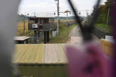 A South Korean military guard post is seen through a military fence