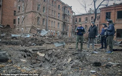 Police officers work near a crater from a Russian missile strike in Kharkiv today