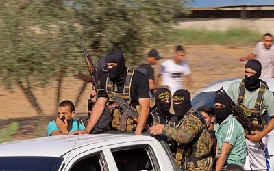 Palestinian Islamic Jihad terrorists are seen on their way to cross the Israel-Gaza border fence from Khan Younis during the Hamas-led onslaught of October 7