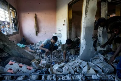 Palestinians search for the remains of their relatives killed in an Israeli bombardment of a school in Deir al-Balah, central Gaza Strip, Thursday, Oct. 10, 2024. (AP Photo/Abdel Kareem Hana)