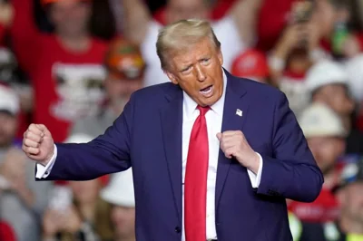 Republican presidential nominee former President Donald Trump dances after speaking at a campaign rally at PPG Paints Arena, Monday, Nov. 4