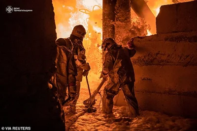 Rescuers work at the site of a Russian drone strike, amid Russia's attack on Ukraine, in Ternopil, Ukraine, in this handout picture released November 26