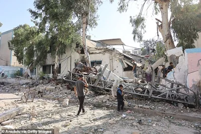 Residents and civil defense team conduct search and rescue operations after the Israeli army targeted Asma School, run by the UN agency for Palestinian refugees (UNRWA) in the Shati refugee camp in Gaza Strip on October 27, 2024