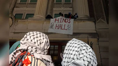 sign displaying "hinds hall" hangs outside building during columbia university takeover