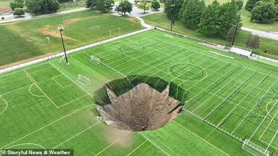 The sinkhole opened suddenly on Wednesday morning in Gordon Moore Park in Alton, Illinois - there were no injuries