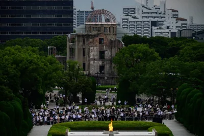 People and reporters gather in front of the ruins of the Hiroshima Prefectural Industrial Promotion Hall, now commonly known as the atomic bomb dome, during the 75th anniversary memorial service for atomic bomb victims at the Peace Memorial Park in Hiroshima on August 6, 2020. AFP PHOTO