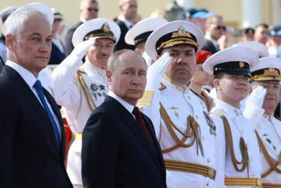 Russian President Vladimir Putin and Russian Defense Minister Andrei Belousov, left, attend the main naval parade marking Russian Navy Day in St. Petersburg, Russia, Sunday