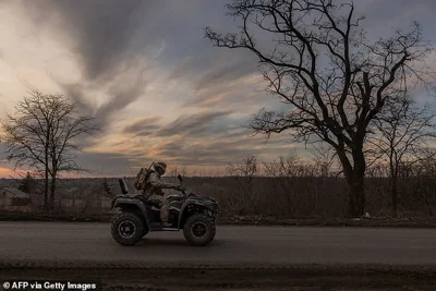 A Ukrainian serviceman drives a quadbike towards the town of Chasiv Yar, March 30