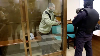 In this photo released by the Moscow City Court Press Service, Stephen Hubbard stands in a glass cage during a court session in the Moscow City court in Moscow, Russia, Monday, Oct. 7, 2024.