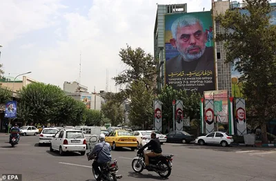 A poster of new Hamas leader Yahya Sinwar hangs on a wall at the Palestine Square in Tehran