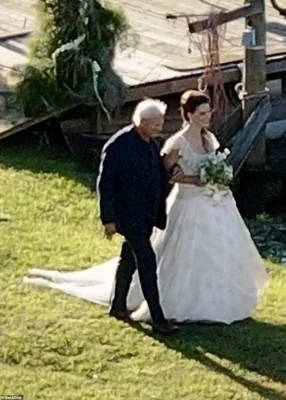 In new photos and videos obtained by DailyMail.com exclusively, the Born To Die hitmaker, 39, is seen being walked down the aisle by her father Robert Grant with a floral bouquet in hand